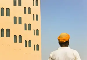Turban Prints: Arabic man with traditional house, old town, Dubai, UAE