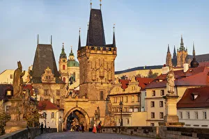 Arch of Lesser Town Bridge Tower on Charles Bridge with St. Nicholas Church in Prague, Czech Republic