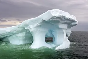 arched iceberg floating off the western Antarctic peninsula, Antarctica, Southern Ocean