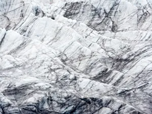 Arctic, Svalbard, Spitsbergen. Ice at the foot of a glacier with the dirt it has scoured