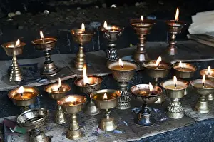 Burning Prints: Asia, Bhutan, Dochu La. Yak butter candles burn in shrine