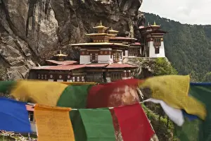 Precipice Prints: Asia, Bhutan. Prayer flags flap near Taktshang or Tigers Nest