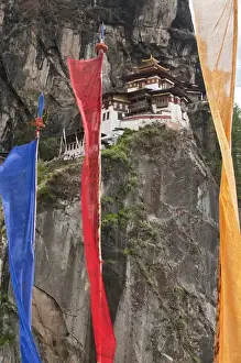 Precipice Prints: Asia, Bhutan. Prayer flags hang near Taktshang or Tigers Nest