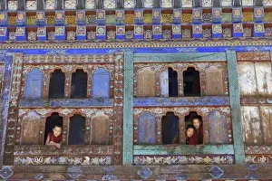 Bumthang Prints: Asia, Bhutan. Young monks take a break from school and look out the windows in Jambey Lhakhang