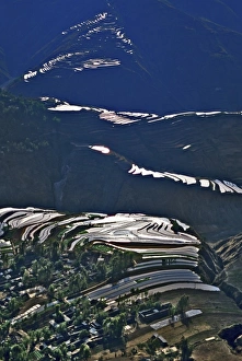 Shine Prints: Asia, China, Yunnan, Dongchuan. Steep mountain flooded terraces around village reflect