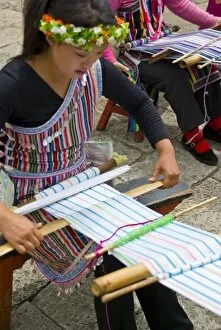Asia, China, Yunnan Province. Back-strap weaving practiced by young Dulong (Drung)