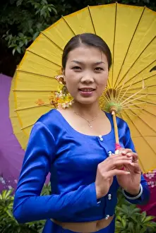 Asia, China, Yunnan Province. Young Dai minority woman in traditional ethnic costume