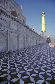 Asia, India, Agra. A marble walkway leads to a minaret at the Taj Mahal, a World Heritage Site