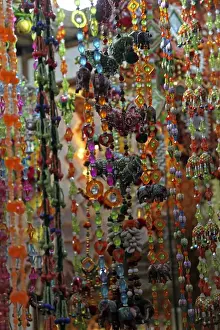 Hanging Prints: Asia, India, Delhi. Colorful strands of beads hang in market in Old Delhi