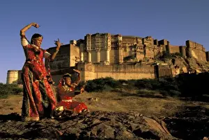 Dance Prints: Asia, India, Jodhpur. Two women dancing in front of Meherangarh Fort. MR