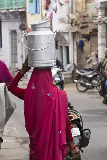 Udaipur Prints: Asia, India, Rajasthan, Udaipur resident with container going to collect fresh goat milk