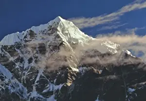 Jagged Prints: Asia, Nepal, Sagarmatha NP. Wispy sunrise clouds glance off Tawache Peak, Sagarmatha NP