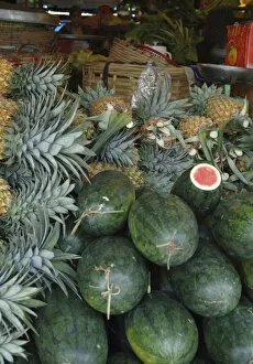 Asia, Vietnam. Watermelons and pineapples for sale at a local market, Can Tho