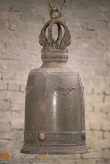 Yunnan Prints: Asian, China, Yunnan Province, Xishaungbanna, Manfeilong Village. Large cast bell