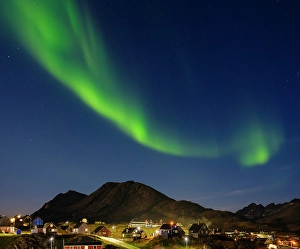 Aurora Prints: Aurora over the town. Town Tasiilaq (former Ammassalik)