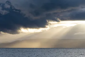 God Ray Prints: Australia, Tasmania, Freycinet National Park Morning light breaks through dark clouds
