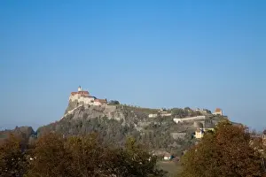 Homes Prints: Austria - Low angle view of a village built on a mountaintop. Horizontal shot