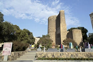 Azerbaijan, Baku. The Maiden Tower in Baku, with artistic representations of it in front