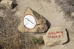 Warning Prints: Azerbaijan, Qobustan. A warning to watch out for snakes at Gobustan National Park