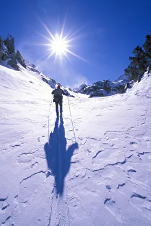 Backcountry skier crossing wind blown snow near Treasure Lakes, John Muir Wilderness Backcountry skier crossing wind blown snow near Treasure Lakes, John Muir Wilderness