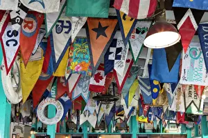 Ceiling Prints: Bahamas, Exuma Island. Flags on ceiling of bar at Yacht Club