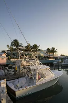 Images Dated 6th April 2007: Bahamas, Grand Bahama Island, Freeport, Setting sun lights power boats at marina