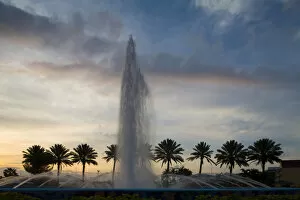 Images Dated 9th April 2007: Bahamas, Grand Bahama Island, Freeport, Setting sun silhouettes fountains and palm