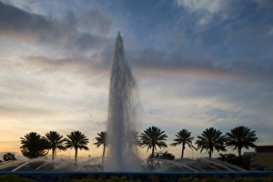 Images Dated 9th April 2007: Bahamas, Grand Bahama Island, Freeport, Setting sun silhouettes fountains and palm