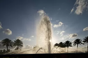 Images Dated 6th April 2007: Bahamas, Grand Bahama Island, Freeport, Setting sun silhouettes fountains and palm