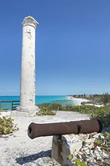 Cannon Prints: Bahamas, Little Exuma Island. Rusty cannon and column marking salt ponds location