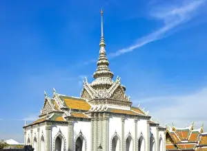 Inti St Clair Prints: Bangkok, Thailand - A Buddhist temple with an ornately decorated roof and white walls