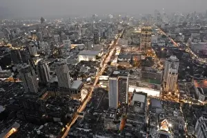 Inti St Clair Prints: Bangkok, Thailand - The downtown district of a city at dusk with smog in the background