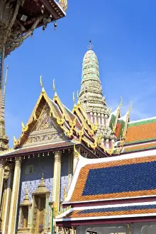 Inti St Clair Prints: Bangkok, Thailand - The entrance to a Buddhist temple showing a high roof and colorful tiles