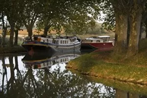 Barges tied up along bank of the Canal du Midi, Aude, Languedoc, France