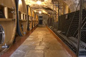 Warehouse Prints: Barrels of wine aging in the cellar Piles of old bottles aging in the cellar Chateau Vannieres