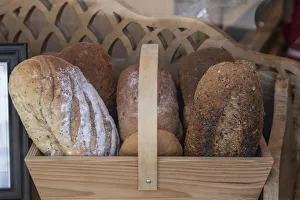 For Sale Prints: Basket of breads was found sitting on a bench outside a bakery in Glastonbury, England