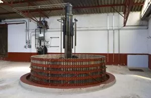 Basket wine press with the hydraulic machinery in the background, Champagne Jacquesson in Dizy