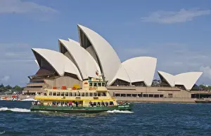 Ferry Prints: Beautiful closeup of famous Sydney Opera House in Sydney Harbour with ferry passing
