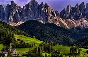 Beautiful isolated lonely church St Maddalena and village in valley in the Italian