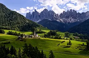 Beautiful isolated lonely church St Maddalena and village in valley in the Italian