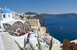 Prints of Beautiful Oia in Greek Island of Santorini Greece and the white buildings looking down from cliffs on holiday Images Dated 2028 September: Beautiful Oia in Greek Island of Santorini Greece and the white buildings looking
