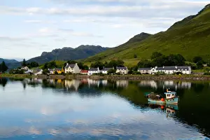 Beautiful photo of small village of Dornie with refections and boat in Western Highlands