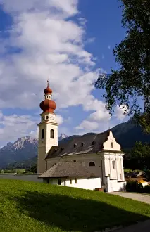 Images Dated 17th October 2020: Beautiful St Stephan Church with steeple with fabulous Dolomites mountains behind