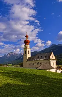 Images Dated 17th October 2020: Beautiful St Stephan Church with steeple with fabulous Dolomites mountains behind