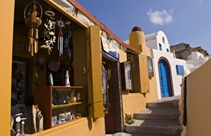 Walk Way Prints: Beautiful village walkway with shops in Oia, Santorini, Greece