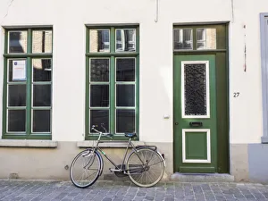 Bicycle Prints: Belgium, Brugge. A bike against a brick wall in Bruges