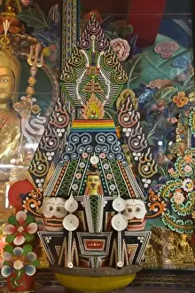 Bhutan. Ceremonial cakes made by monks adorn the altar in a Buddhist temple