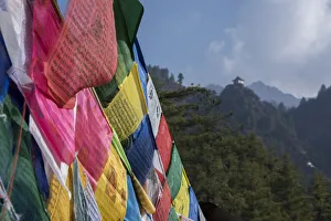 Select Focus Prints: Bhutan, Paro. Colorful prayer flages in front of small outbuilding of the Tigers Nest