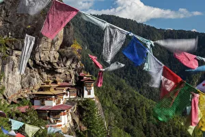 Buddhism Prints: Bhutan, Paro. Prayer flags fluttering at the cliffs edge across from Taktsang Monastery