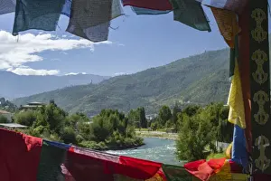 Buddhism Prints: Bhutan, Punakha. Prayer flags line the cantilever bridge over the Mo Cchu river